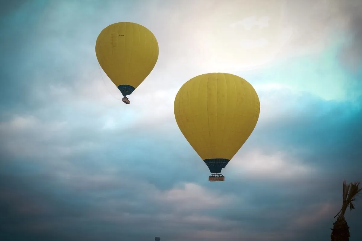Two yellow balloons flying in the sky over Marrakech